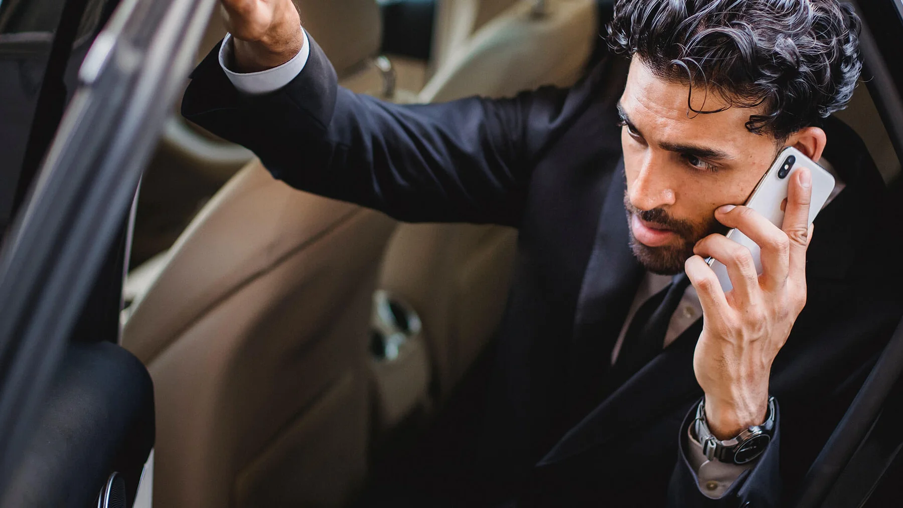 A passenger settling into a luxury vehicle